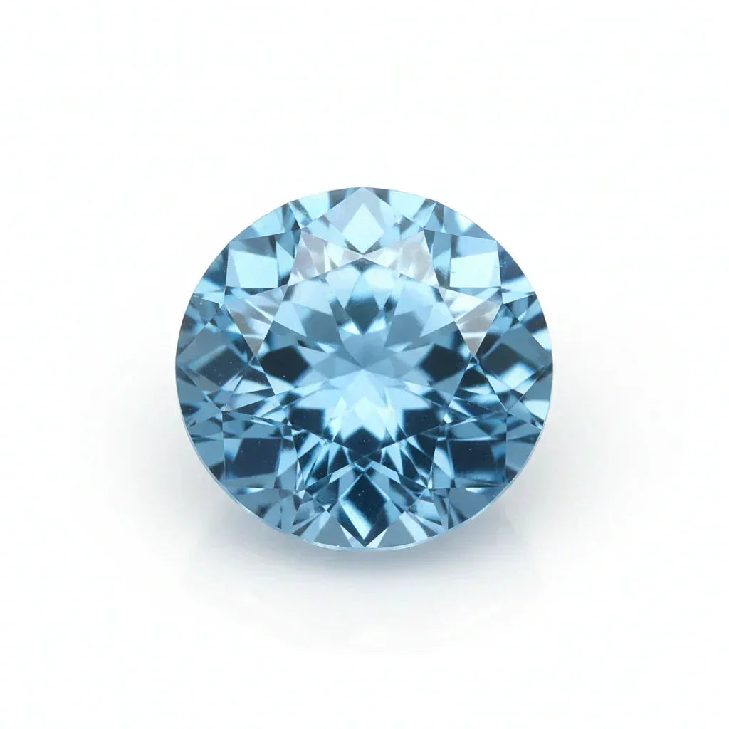 Round natural blue zircon gemstone with brilliant cut on white background